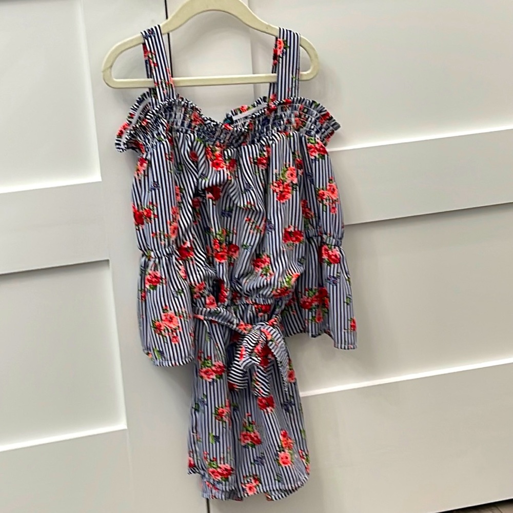 This is a romper with stripes and flower designs and a matching belt